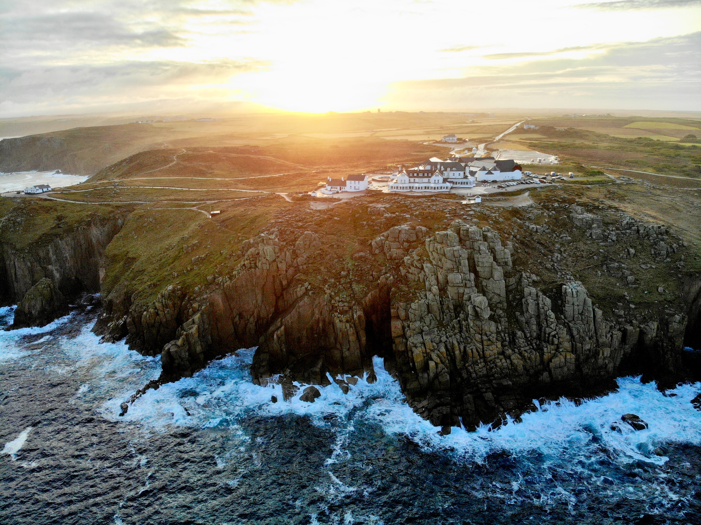 Cliffs and visitor buildings at Land&rsquo;s End on the Atlantic coast of Cornwall at sunset