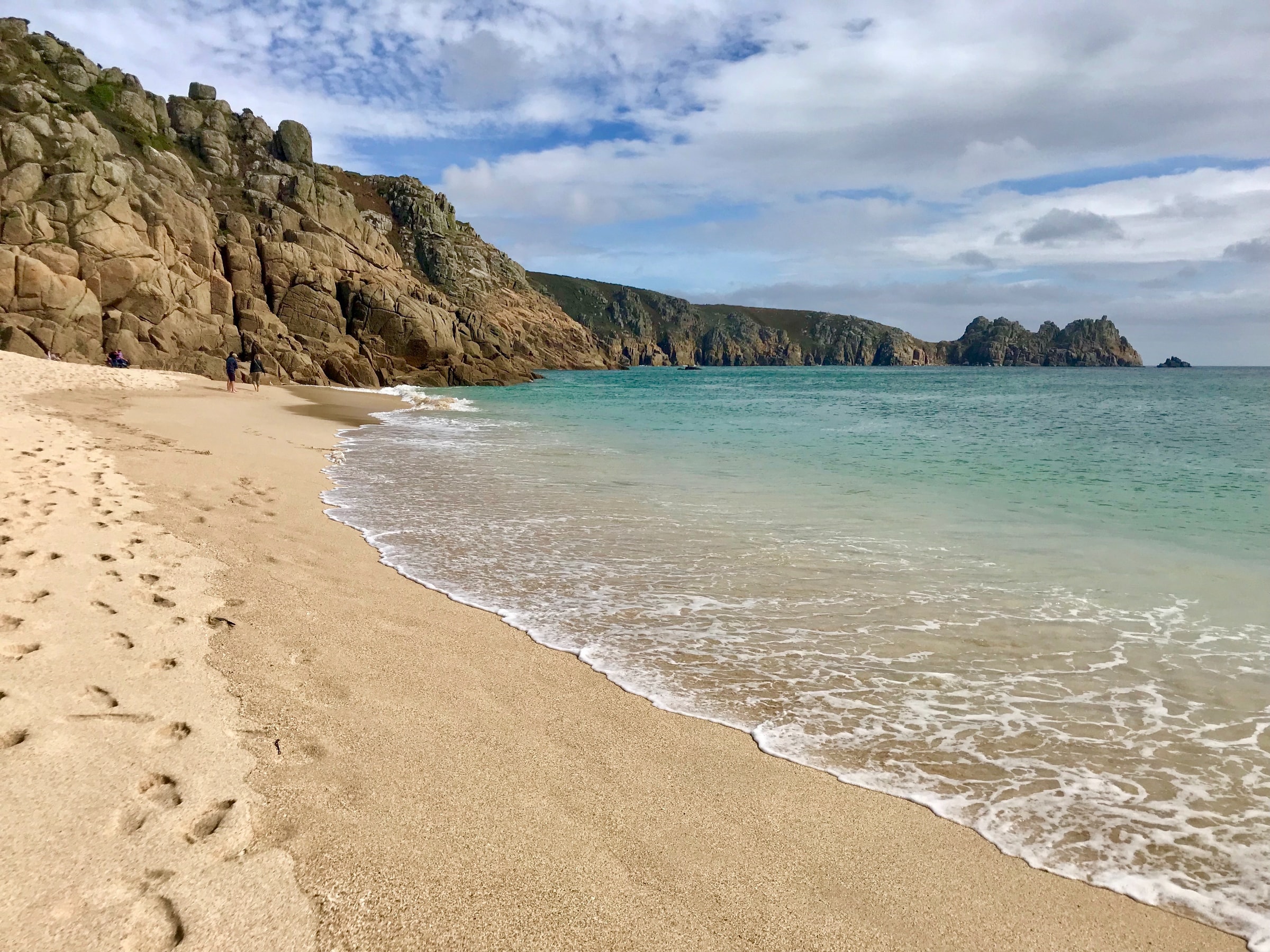 Sandy cove beach near Penzance with turquoise water and granite cliffs along the West Cornwall coast