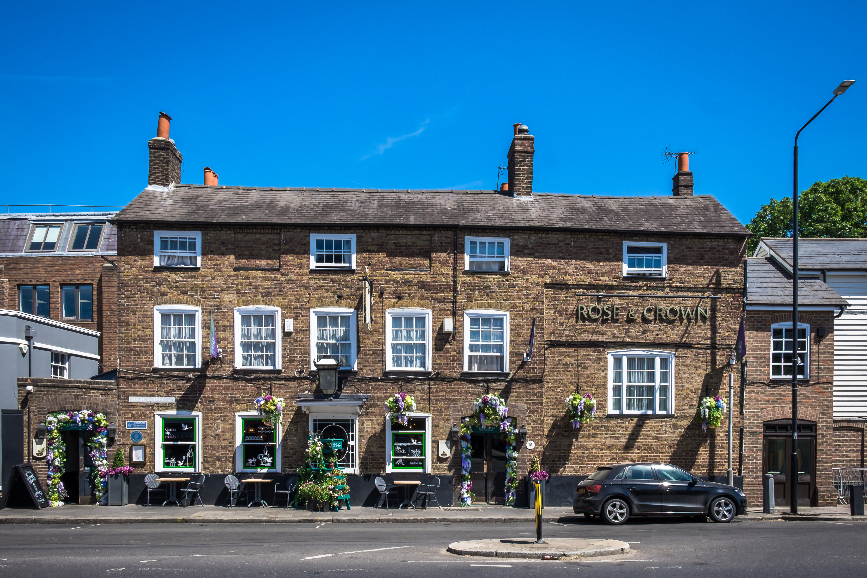 Exterior of The Rose and Crown in Wimbledon Village, a traditional pub with rooms on a sunny day.